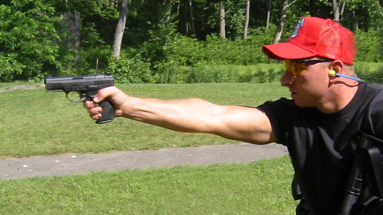 NRA Instructor shooting on an outdoor range.